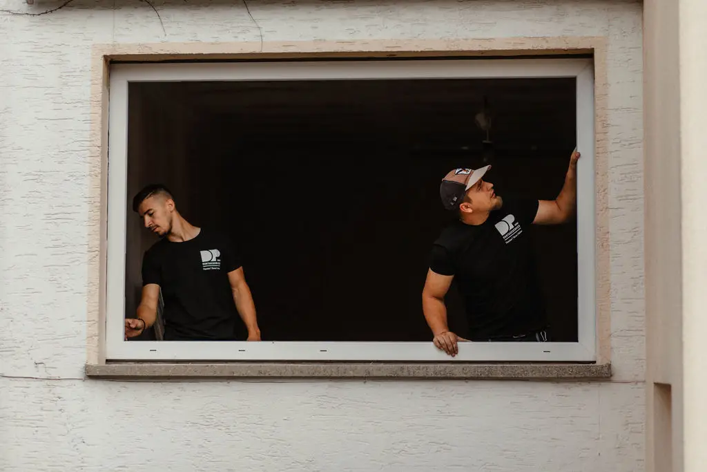 Zwei Mitarbeiter von DP Montageservice bei der Fenstermontage in einem Altbau